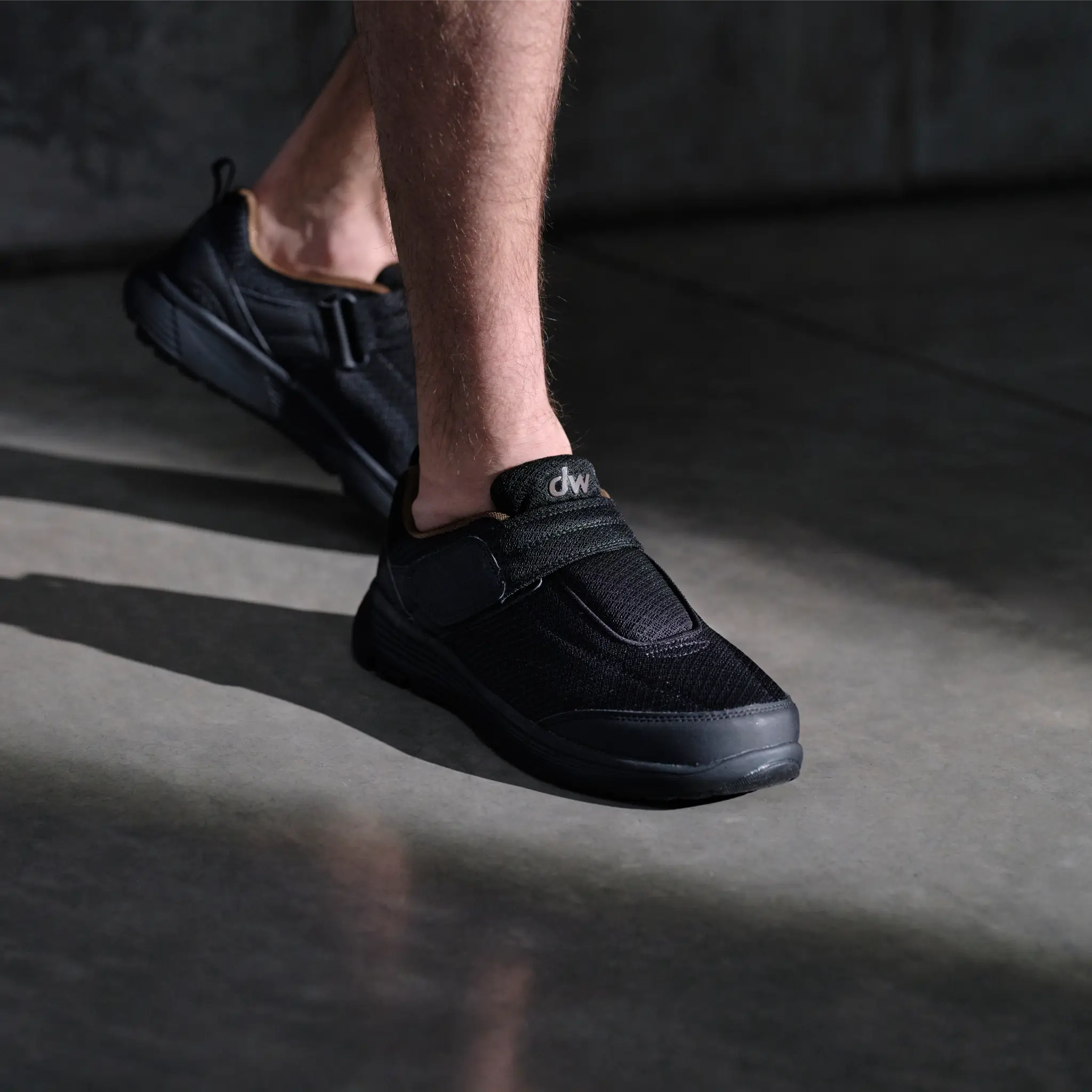 Man wearing black Diawin wide-fit sneakers for walking