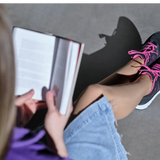 Diawin black sneakers for wide and diabetic feet during a relaxing reading session.