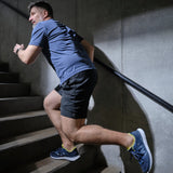 Man running up stairs in Diawin navy sneakers for wide and diabetic feet.