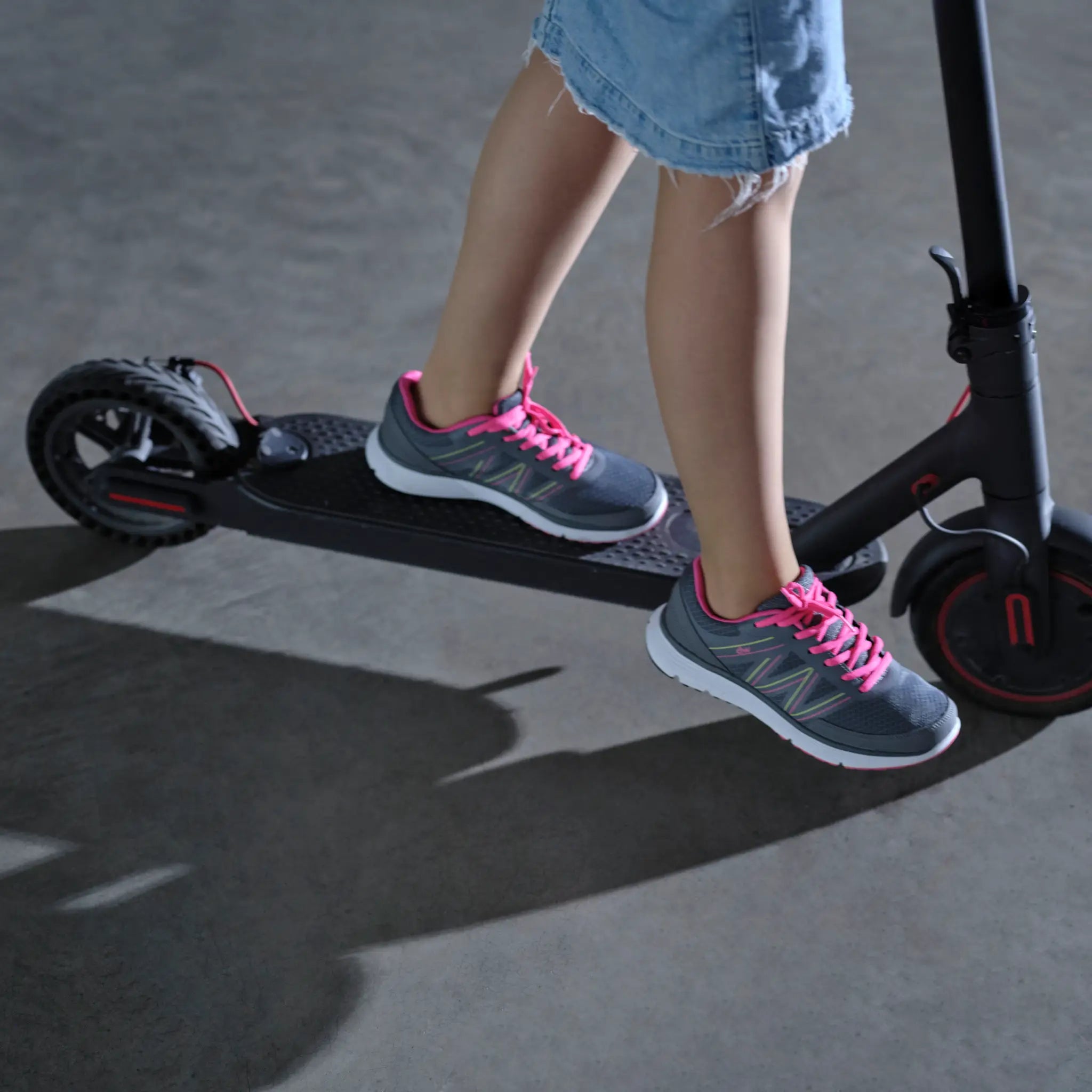 Girl riding a scooter wearing DW sneakers for wide and diabetic feet.